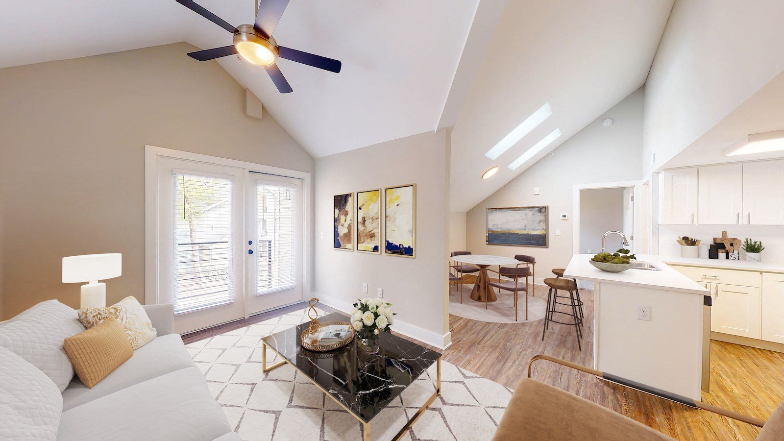 a living room with a couch and a ceiling fan